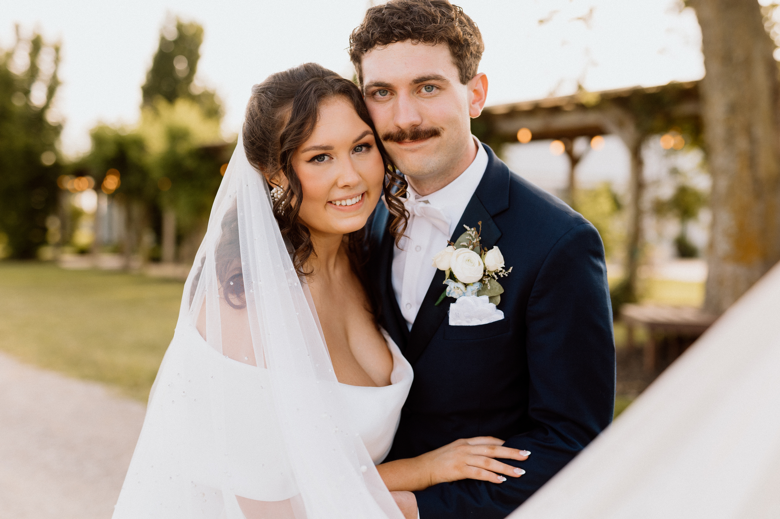 Couple in wedding attire with glowy light at Chenault Vineyards